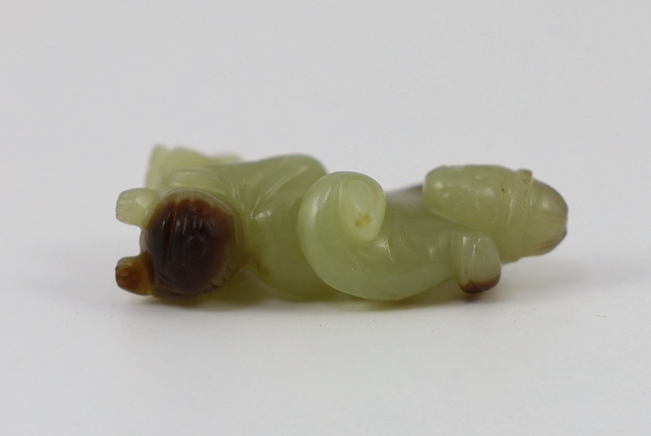 A Chinese yellow and brown jade figure of a man seated on a creature, 19th century, 4.3cm high